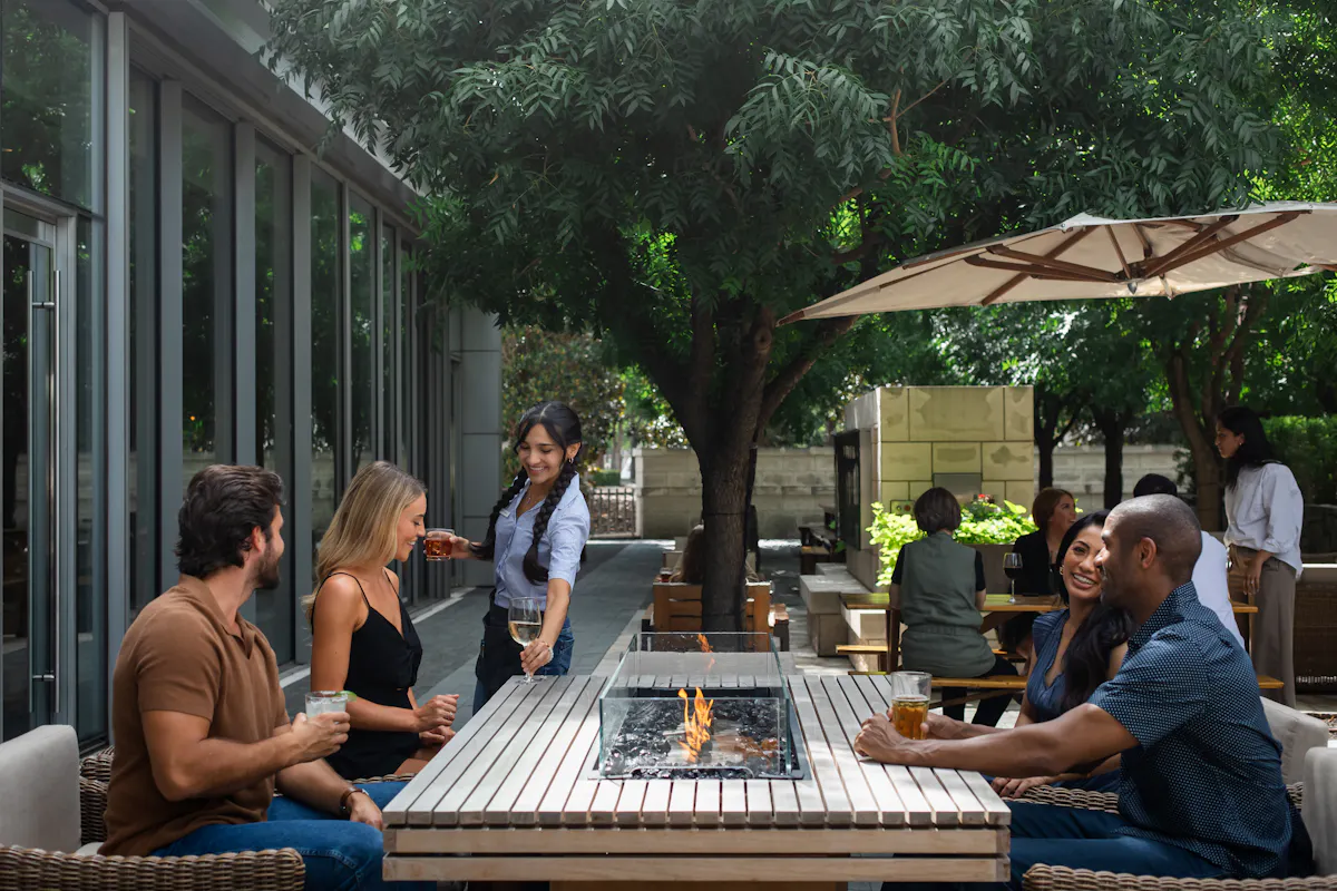 a group of people sitting at a table with drinks